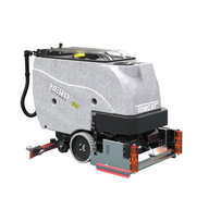 Tomcat® walk-behind scrubber with gray cylindrical body, black control box and red accents