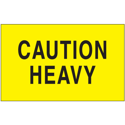 Fluorescent yellow caution heavy label with black text, rectangular