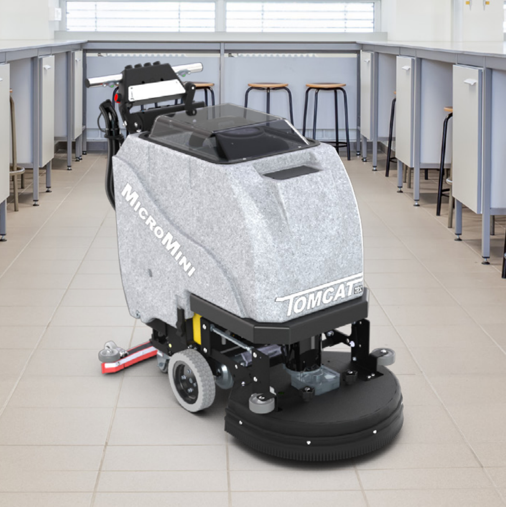 Walk-behind floor scrubber with gray housing, black head, and front wheels