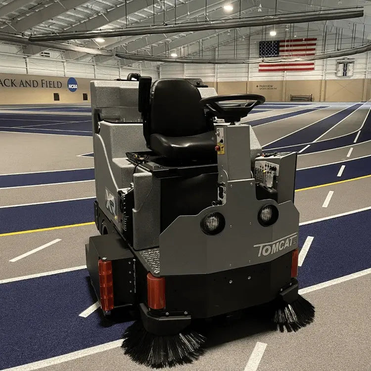 Tomcat® rider floor scrubber with rear lights, front brush, and driving console